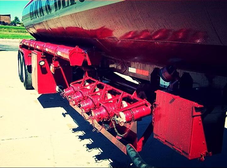 red painted tank trailer with nozzles